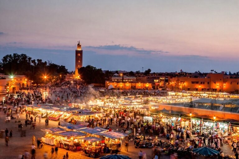 Lively city square at night in Morocco with lights and people