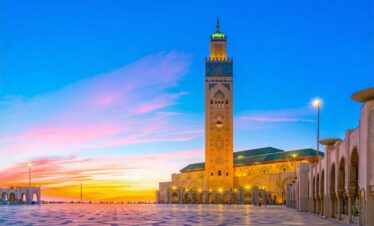 Hassan II Mosque in Casablanca, Morocco during sunset with glowing minaret