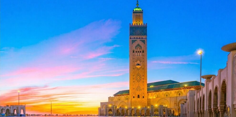 Hassan II Mosque in Casablanca, Morocco during sunset with glowing minaret