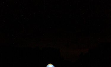 Berber tent in Jebel Saghro at night under a star-filled desert sky